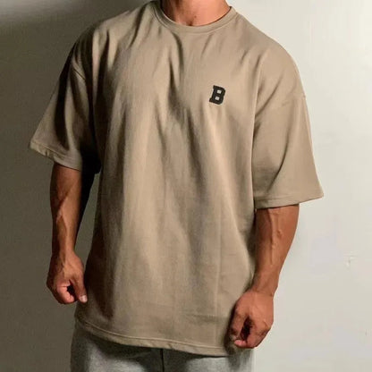 Camiseta de fitness oversize para hombre con cuello redondo y hombros caídos - camiseta informal de entrenamiento para fitness, entrenamiento, running y tiempo libre