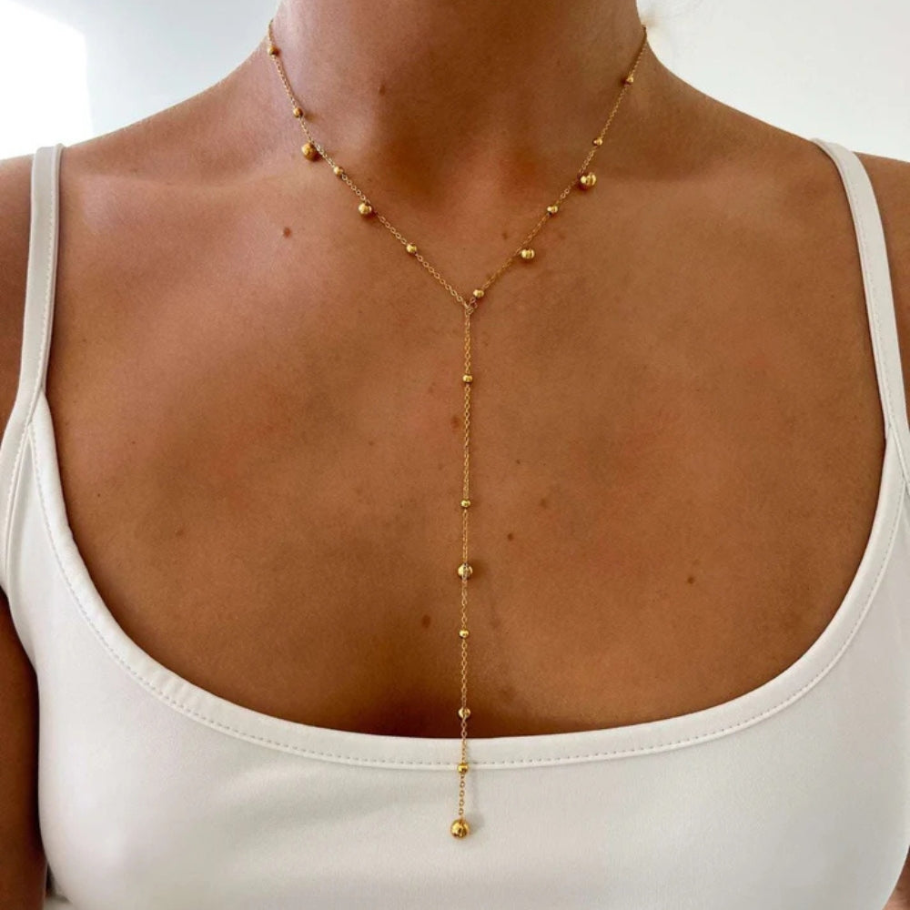 Women's gold-colored Y necklace in stainless steel with a pearl chain and long teardrop design – elegant jewelry for everyday wear, parties, and evening styling