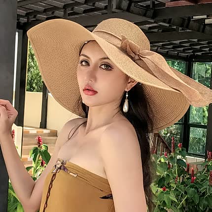 Women's straw hat with a wide brim and bow detail – elegant summer hat for the beach, holidays, garden, and sunny days
