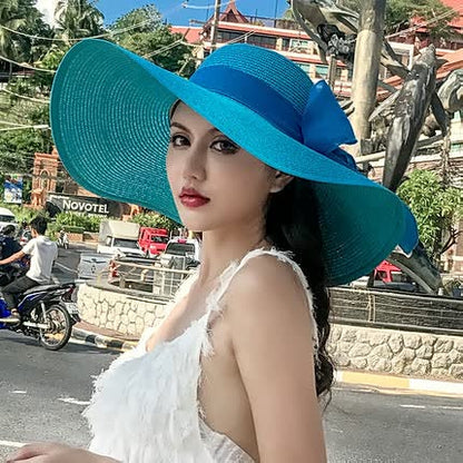 Women's straw hat with a wide brim and bow detail – elegant summer hat for the beach, holidays, garden, and sunny days