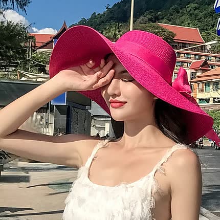 Women's straw hat with a wide brim and bow detail – elegant summer hat for the beach, holidays, garden, and sunny days
